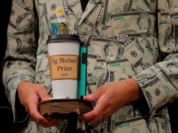 Timothy Voss holds the 2019 Ig Nobel Prize in Economics at the 29th First Annual Ig Nobel Prize Ceremony in Cambridge